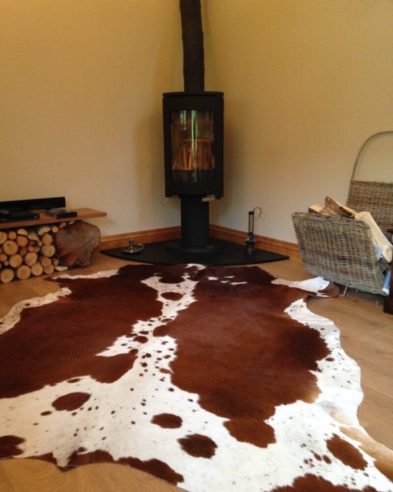 Brown and White Cowhide Rugs - Image 8